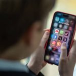 BATH, UNITED KINGDOM - FEBRUARY 25: In this photo illustration a a 12-year-old school boy looks at a iPhone screen A 12-year-old boy looks at an iPhone screen showing various social media apps including TikTok, Facebook and X on February 25, 2024 in Bath, England. This week the UK government issued new guidance backing headteachers in prohibiting the use of mobile phones throughout the school day, including at break times. Many schools around the country are already prohibiting mobile phone use over concerns. The amount of time children spend on screens each day rocketed during the Covid pandemic by more than 50 per cent, the equivalent of an extra hour and twenty minutes. Researchers say that unmoderated screen time can have long-lasting effects on a child's mental and physical health. Recently TikTok announced that every account belonging to a user below age 18 have a 60-minute daily screen time limit automatically set. (Photo by Matt Cardy/Getty Images)