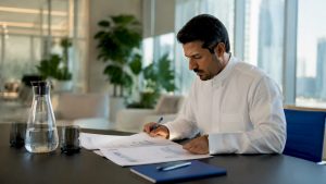 Middle Eastern business leader reviewing improvement process documents