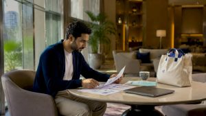 Business analyst reviewing ERP brochures in office