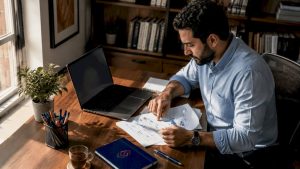 Middle Eastern man reviewing BPM software documents