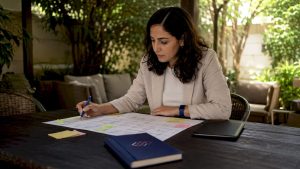 Woman reviewing workflow diagram at table