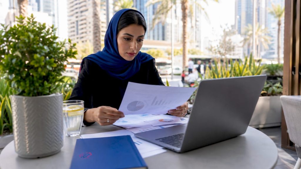 Businesswoman working with analytics reports in office