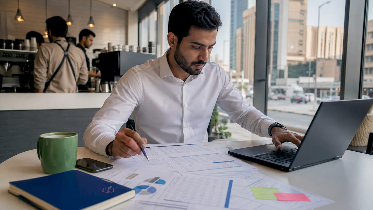 Man reviewing ERP budget documents in office