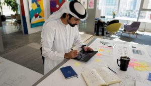 Emirati developer designing app in office