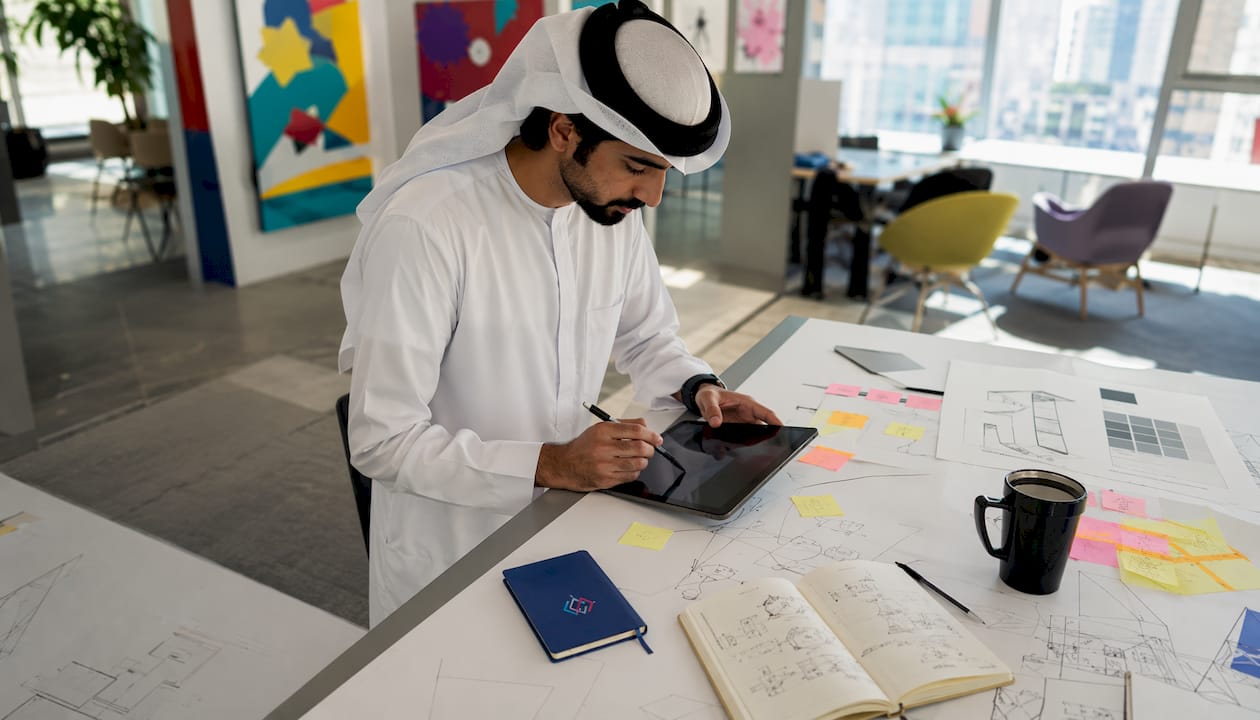 Emirati developer designing app in office