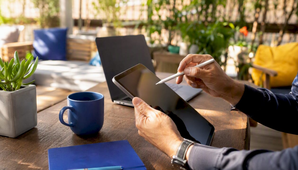 Hands interacting with digital workflow tablet