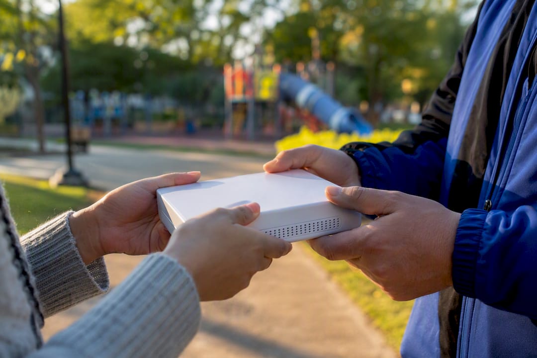 Customer hands receiving telecom installation box