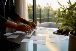 Hands arranging low-code workflow diagrams