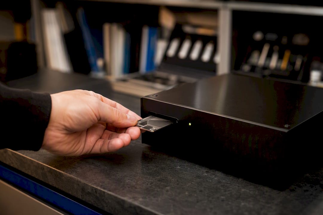 Hand inserting security key in data center
