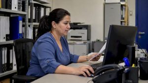 Coordinator checks facilities invoice records